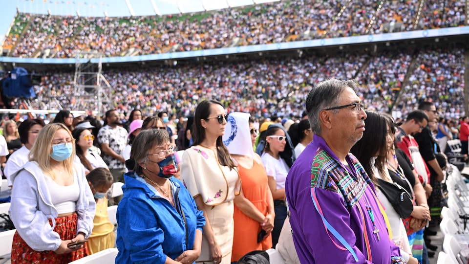 Devotees attend Pope Francis' mass at Commonwealth Stadium. 