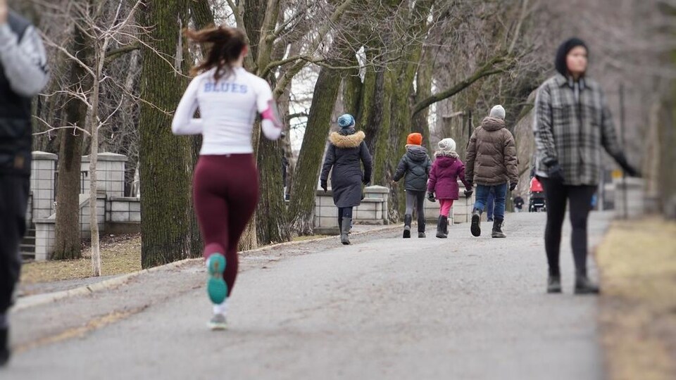 Des coureurs et des marcheurs sur un chemin asphalté réservé aux piétons, le long du parc La Fontaine.