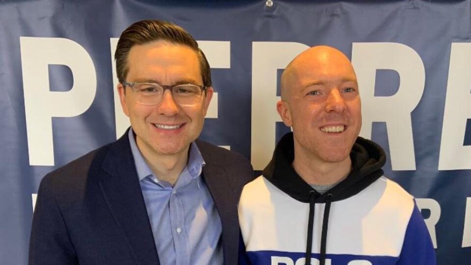 Pierre Poilievre and an activist.