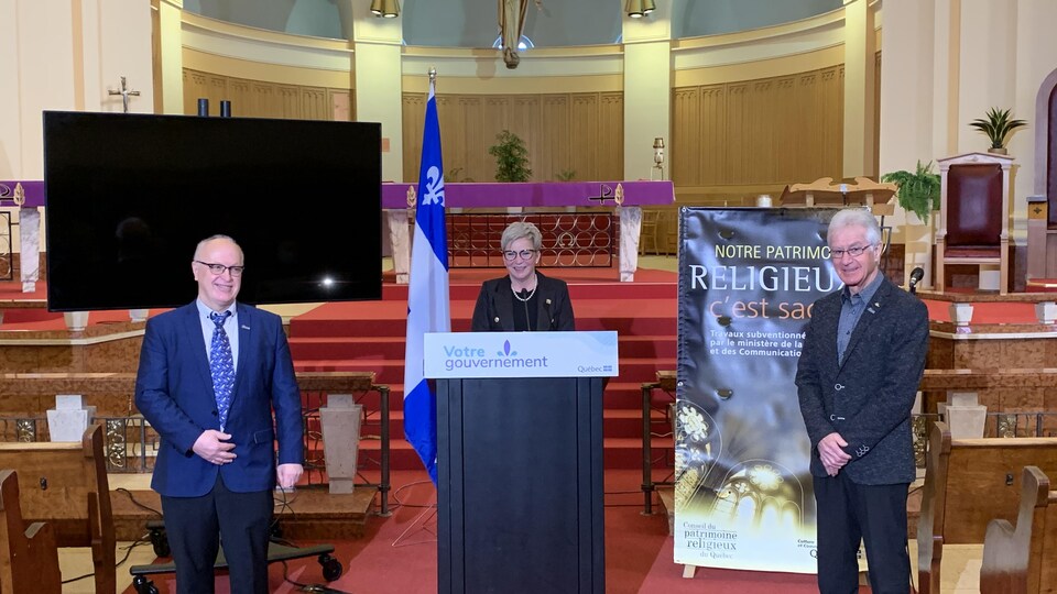 Pierre Roch, président de la Fabrique Sainte-Thérèse-d'Avila, la députée Suzanne Blais et Ghislain Roy, président de la Fondation Héritage de la cathédrale sourient à la caméra.