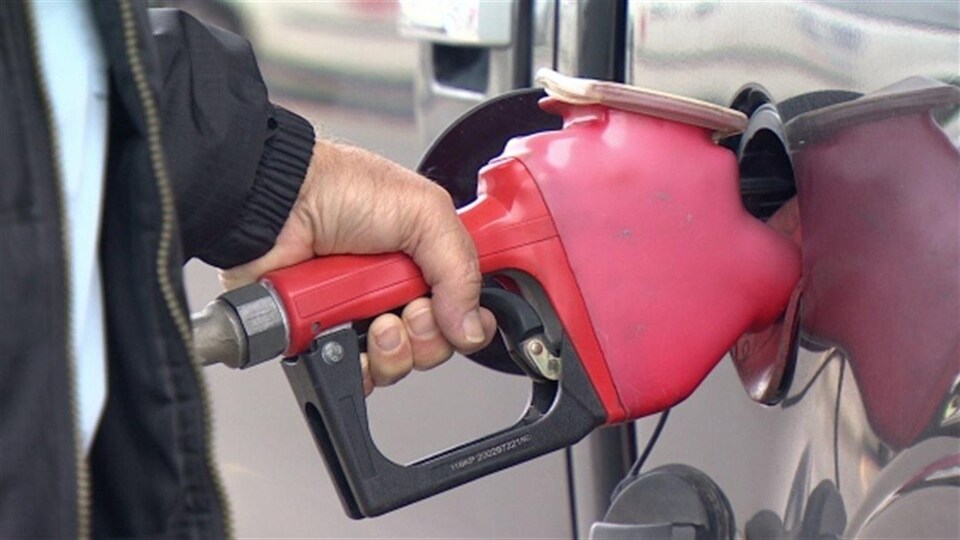 Un automobiliste fait le plein d'essence.