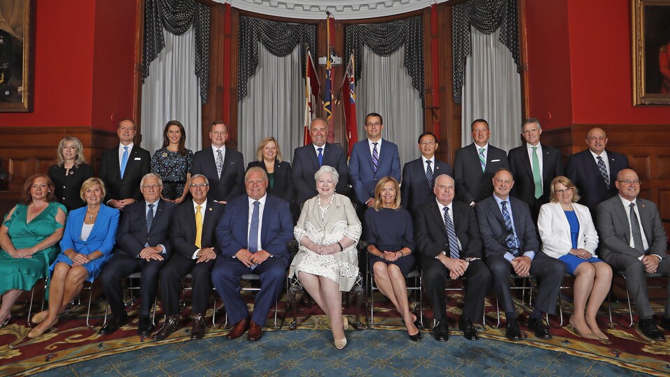 Men and women sitting in two rows for a group photo