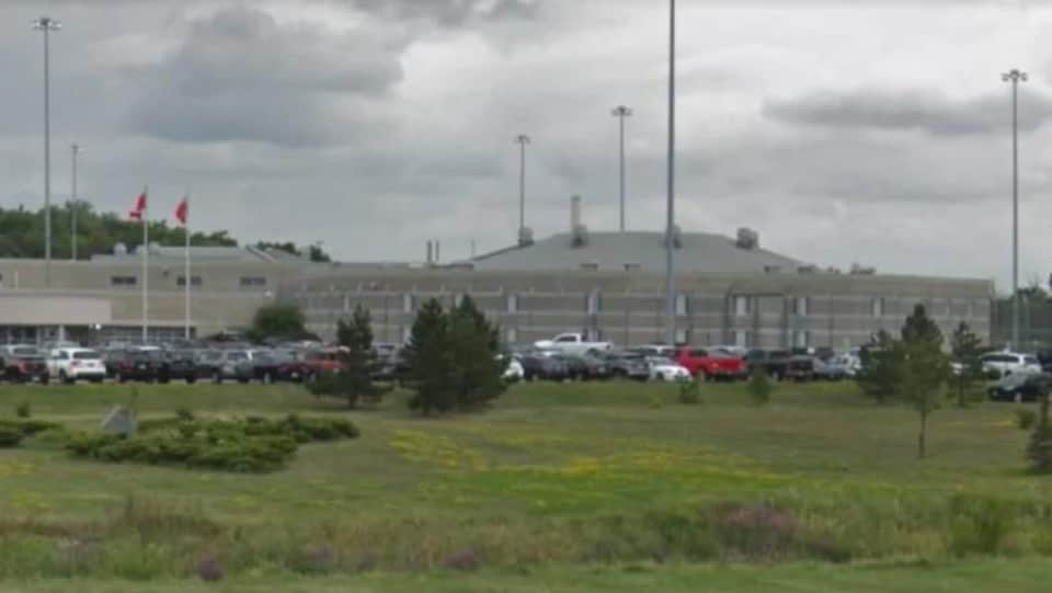 une vue du parc de stationnement avec de l'herbe devant la prison