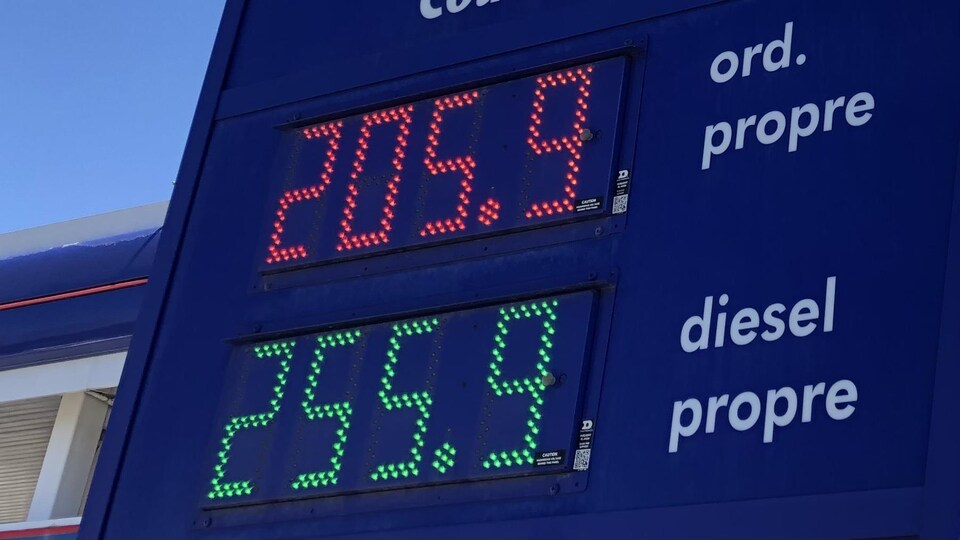 Plan rapproché d'une enseigne de station-service affichant des prix de 205,9 ¢ pour le litre d'essence ordinaire et de 255,9 ¢ pour le litre de diesel.