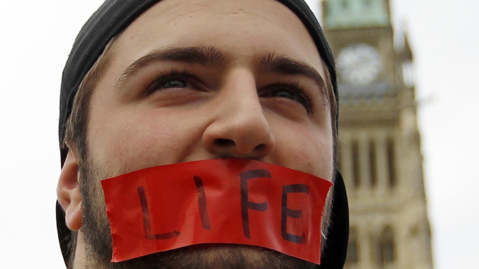 Un manifestant anti-avortement devant le Parlement à Ottawa.