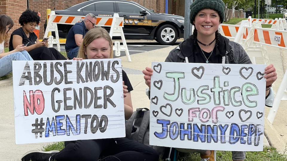 Two women were holding signs in English: one read ‘Abuse is genderless #MenToo’, and the other, ‘Justice for Johnny Depp’.