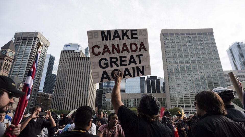 Des manifestants brandissent une pancarte portant le slogan « Make Canada great again ».