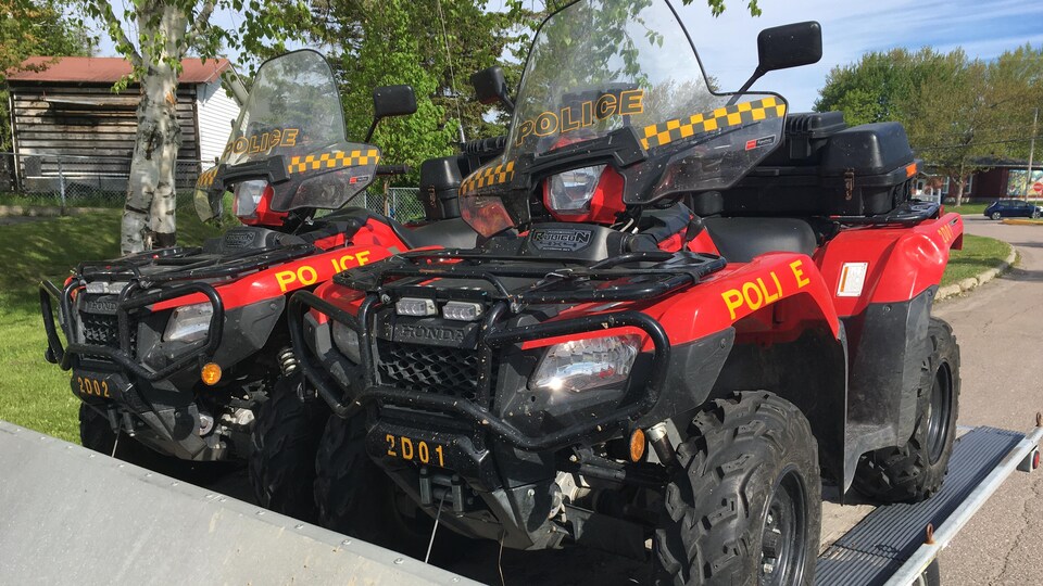 A trailer carrying two ATVs.