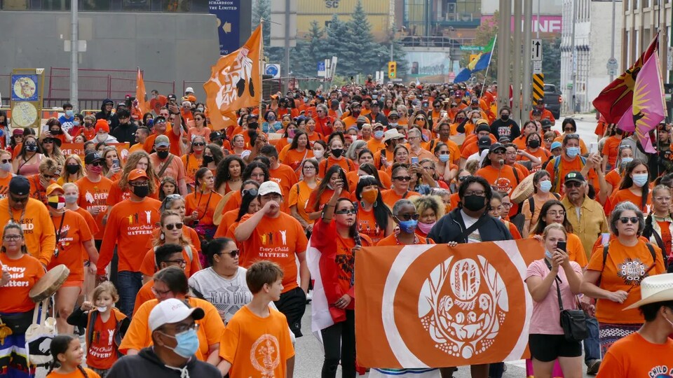 Des milliers de personnes marchent dans les rues de Winnipeg arborant un chandail orange.