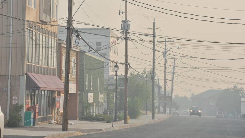 Une rue presque déserte est enfumée.