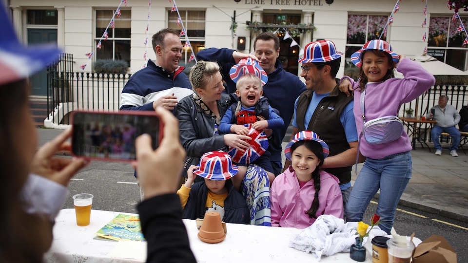 A British family picnicking on a street in London, with a crying baby.