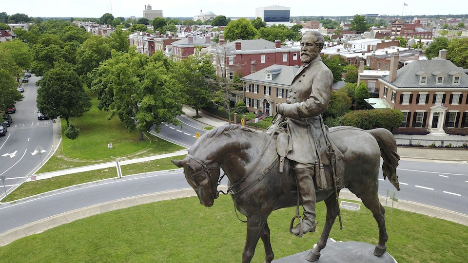 Le général Robert Lee assis sur un cheval au sommet d'un monument de pierre.