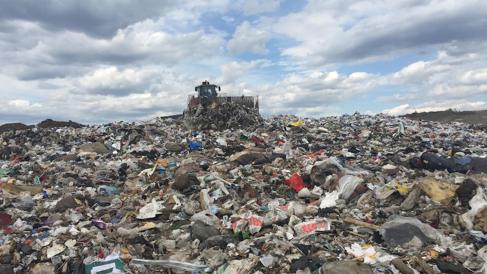 Des camions enfouissent les déchets sur le site d'enfouissement à Lachenaie.