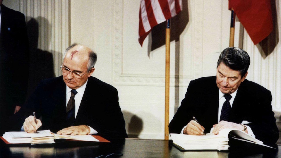 Les présidents des États-Unis, Ronald Reagan (à droite), et de l'URSS, Mikhaïl Gorbatchev (à gauche), signent un traité.