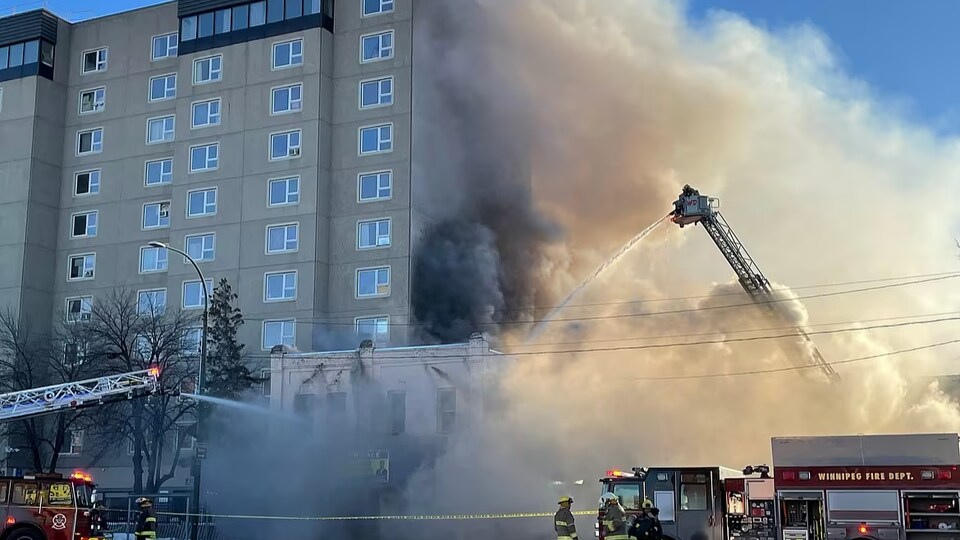 Un bâtiment brûle sur la rue Main, le 4 mars 2023. Des camions de pompiers essayent d'éteindre le feu.