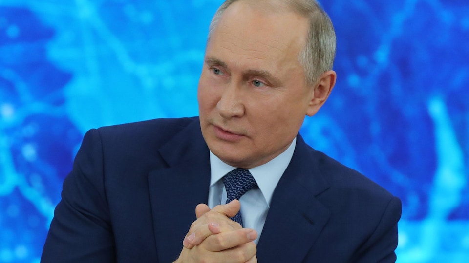 Vladimir Putin rubs his hands.