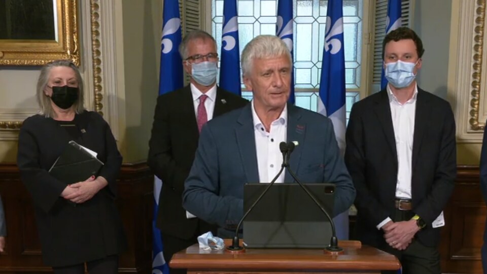 Marc L'Heureux in front of a lectern.