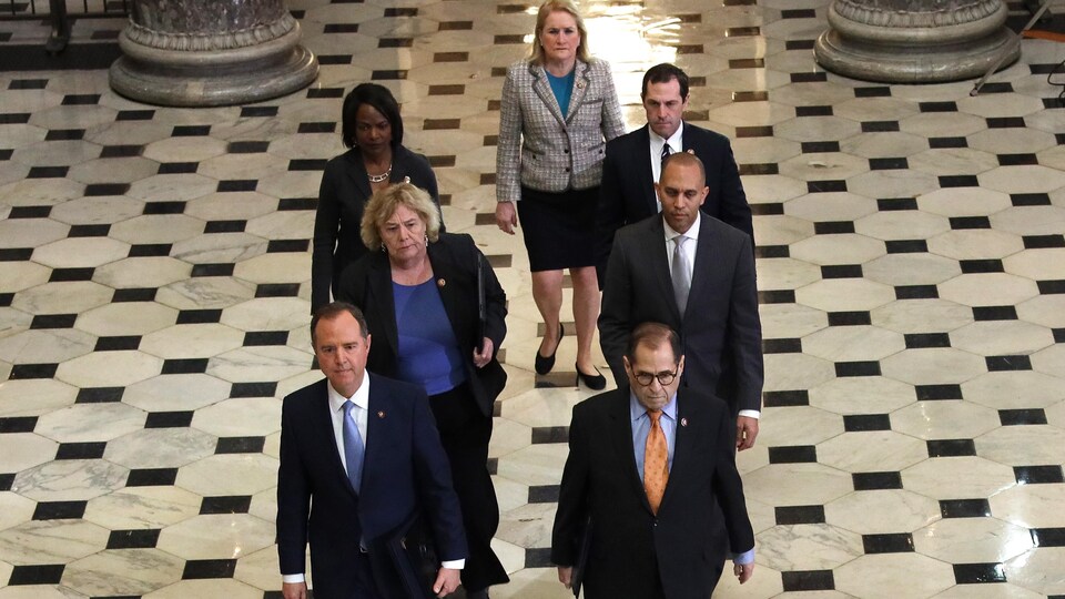 L'équipe des sept responsables de la mise en accusation marche en direction du Sénat dans les couloirs du Capitole.