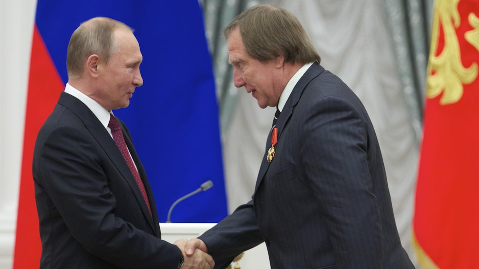 Sergei Pavlovich Roldugin and Vladimir Putin shook hands.