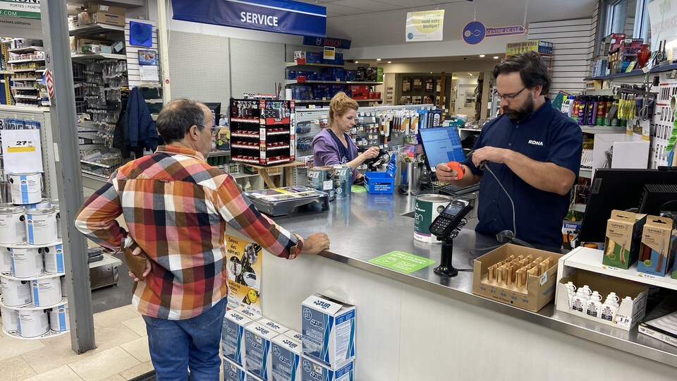 The cashier at a hardware store is in the middle of a transaction.