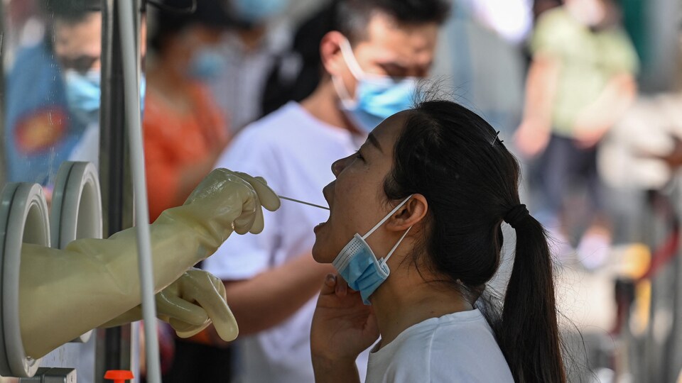 A woman was examined by a healthcare worker in Shanghai.