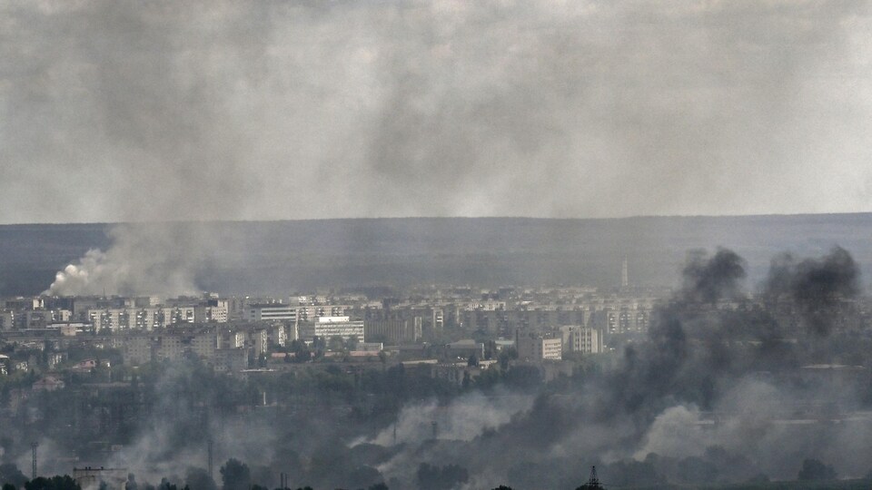 Smoke rises from a city.