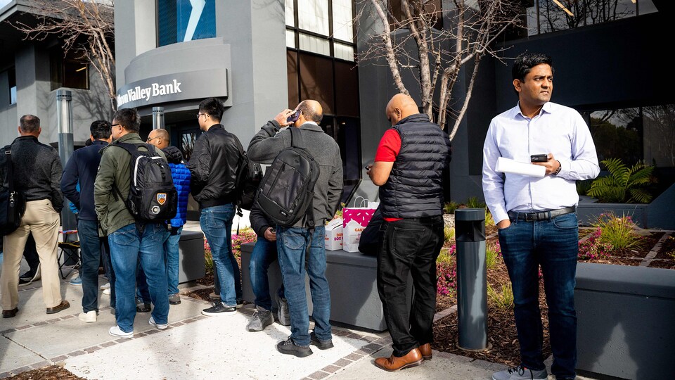 Une dizaine de personnes font la file devant les bureaux de la SVB.