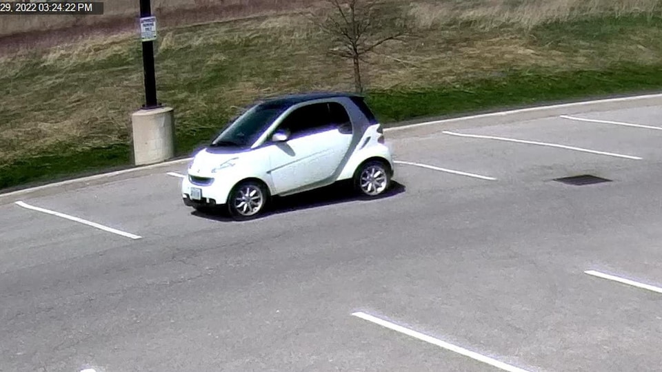 A Smart car in a parking lot.
