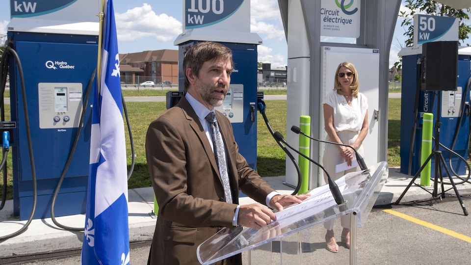 Steven Guilbeault en conférence de presse devant des bornes de recharge du stationnement du Cosmodôme de Laval.