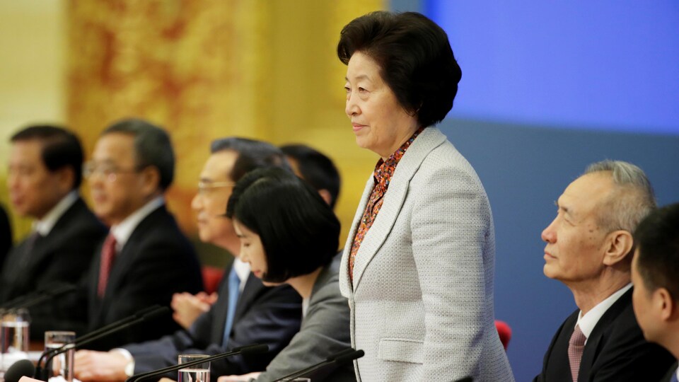 La vice-première ministre de la Chine, Sun Chunlan, debout, au micro.