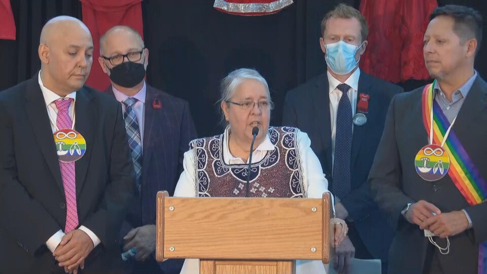 Sylvia Maracle surrounded primarily by David Lametti and Marc Miller.