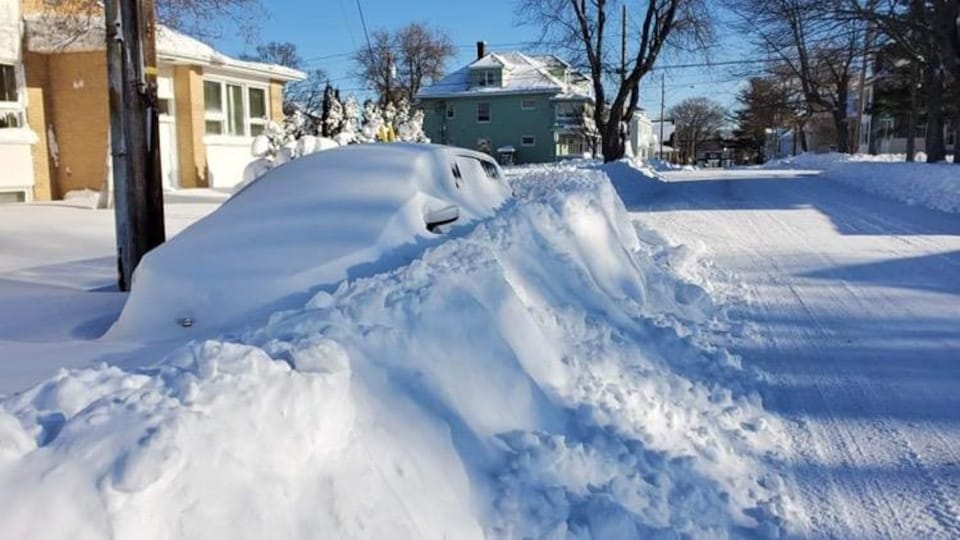 Un véhicule est enseveli sous la neige, samedi matin à Moncton, après le passage d'une importante tempête de neige.