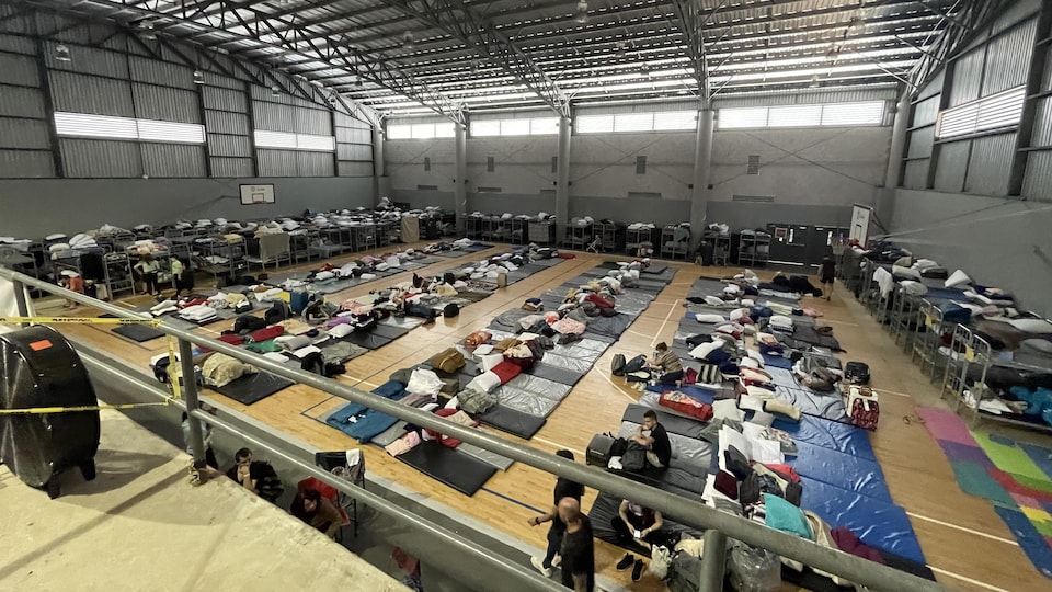 Ukrainians rest at the Benito Juarez Center while waiting to cross the American border.