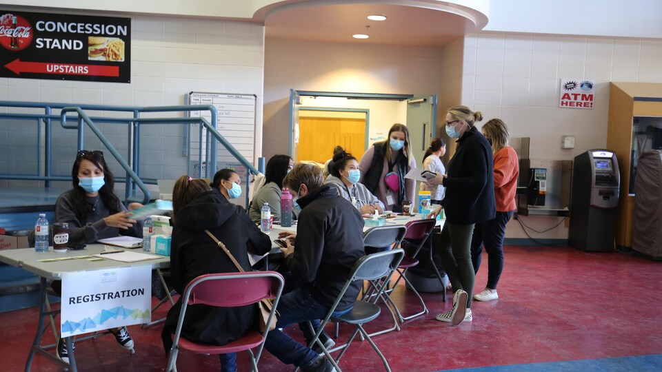 People sit at tables at Yellowknife Sports Center on May 12, 2022. 