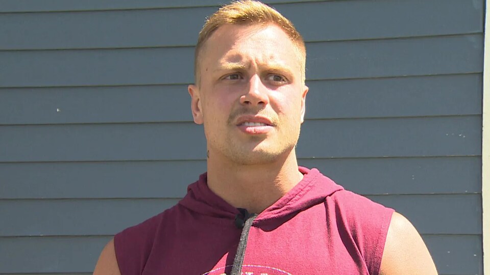 Jordan Tobin being interviewed in front of the building.