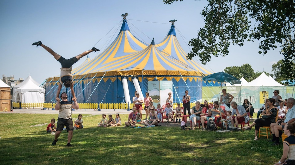 Des artistes de cirque performent à la TOHU à l'extérieur durant l'événement Grains de ciel en juin 2022. 