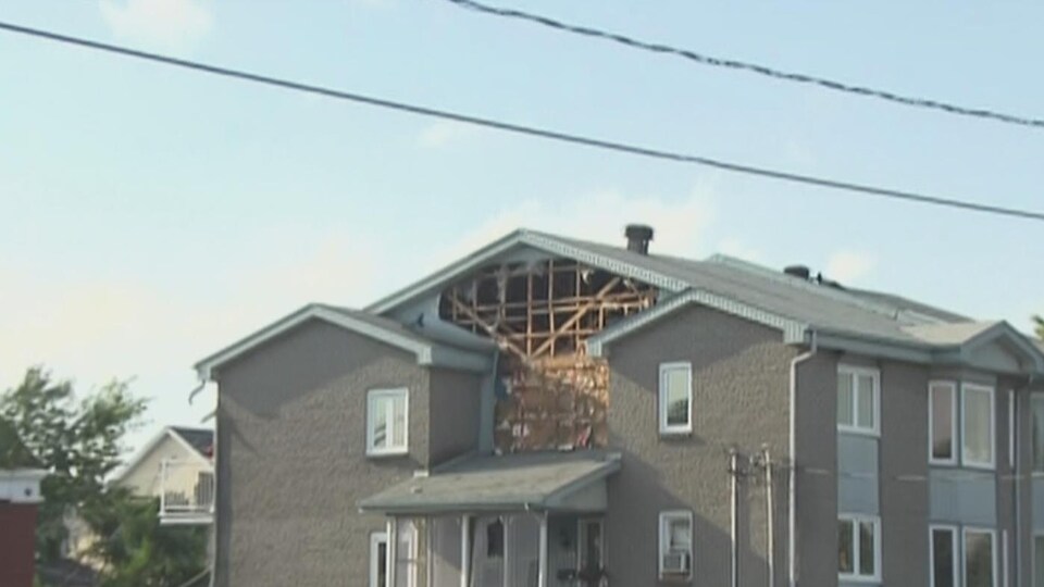 The side of a building is torn.