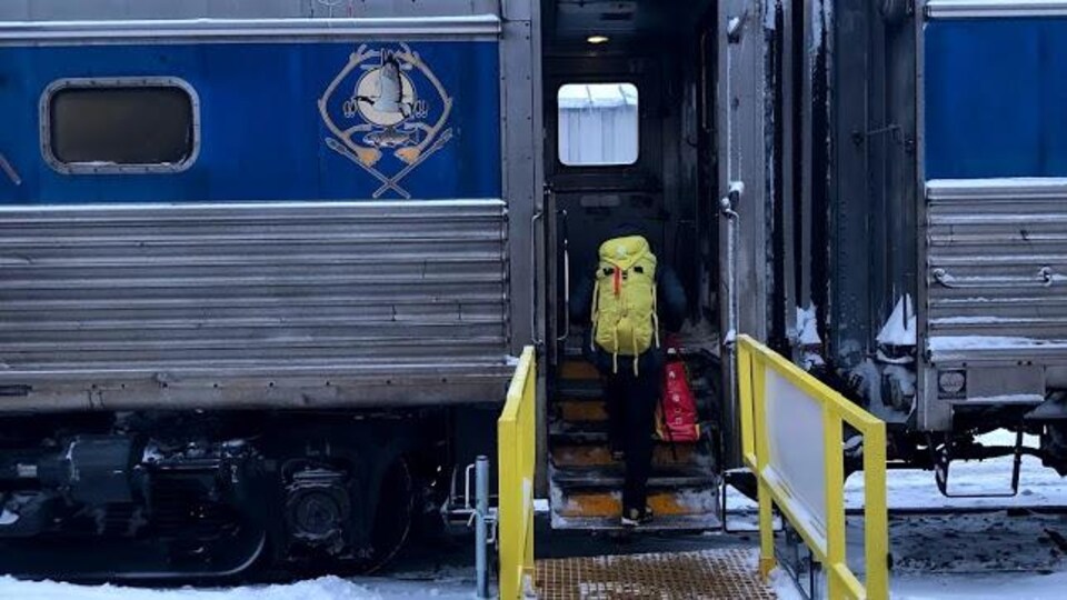 Une passagère embarque dans le train.