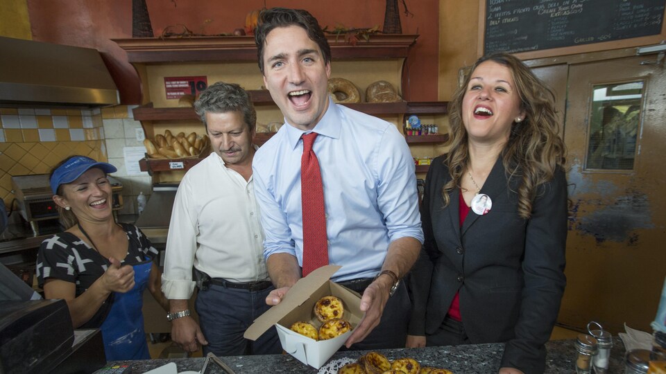 Justin Trudeau et Julie Dzerowicz s'arrêtent dans un café du petit Portugal de Toronto lors de la campagne fédérale de 2015. Ils montrent des tartes portugaises.