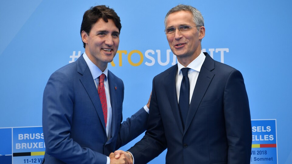 Canadian Prime Minister Justin Trudeau (left) shakes hands with NATO Secretary General Jens Stoltenberg (right).