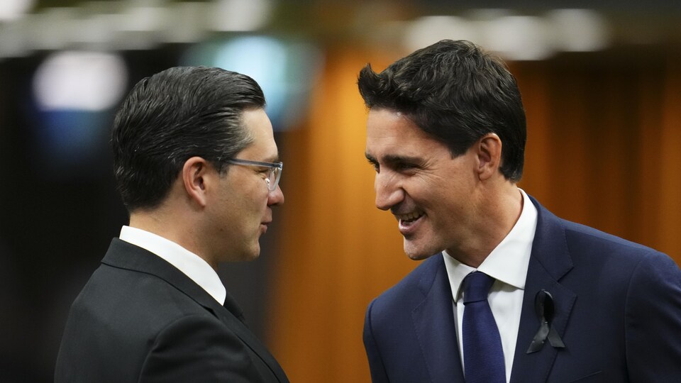 Le premier ministre Justin Trudeau et le chef conservateur Pierre Poilievre se saluent à la Chambre des communes lors d'un hommage à la reine Élisabeth à Ottawa le jeudi 15 septembre 2022.