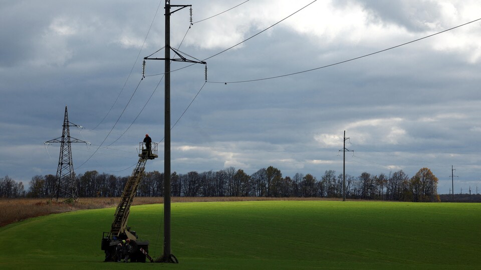 An electrician is working on fixing a power line.