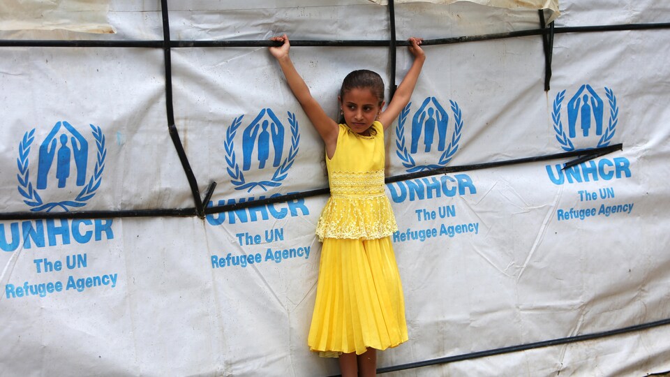 Une jeune Syrienne devant une tente du Haut-Commissariat des Nations unies pour les réfugiés au Liban