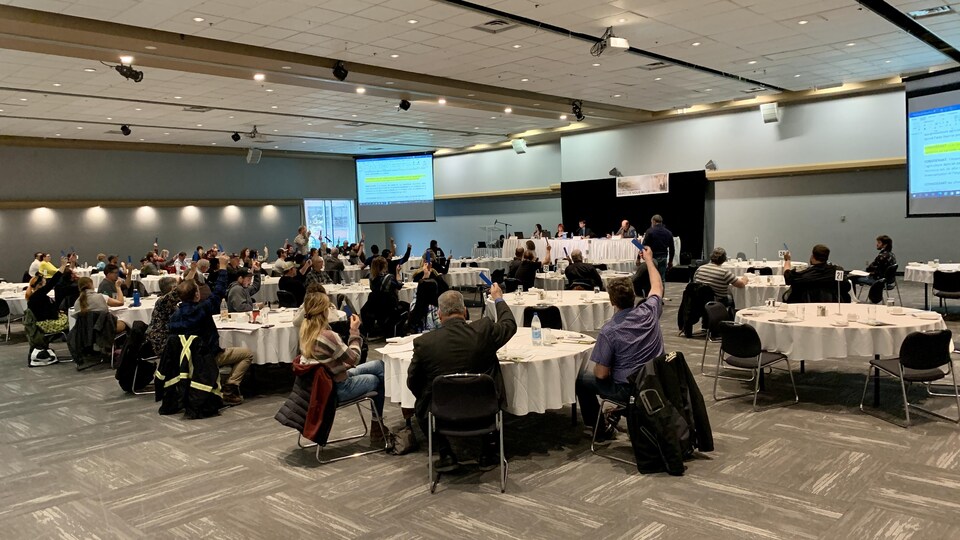 Des membres de l'Union des producteurs agricoles rassemblés autour de plusieurs tables.