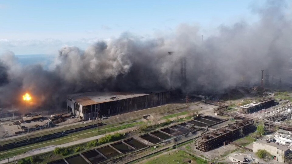 Aerial view of the Azovstal plant with fire and lots of smoke. 