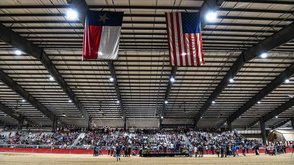 People gather in a rodeo hall.