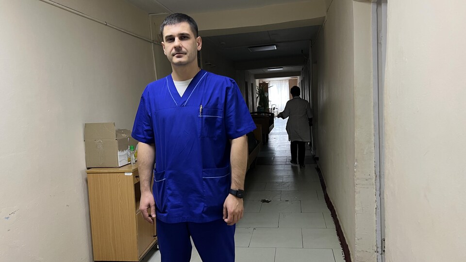 Vadim Sergeevich poses for the camera in a hallway.