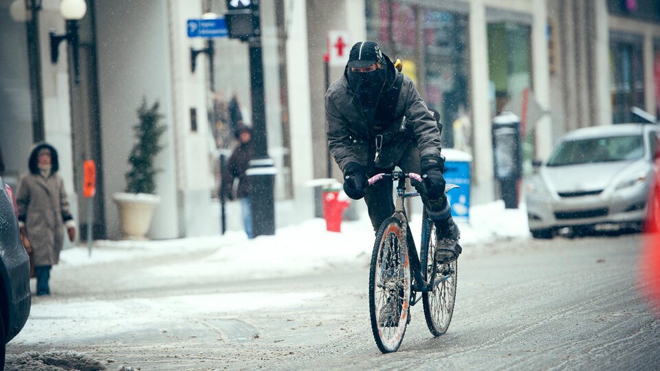 Un cycliste s'adonne au vélo d'hiver en milieu urbain