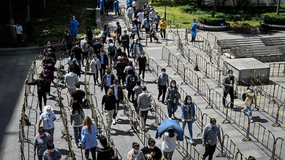 Men and women line up on a street
