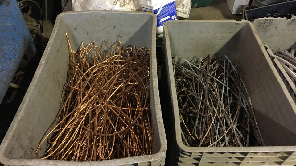 Des câbles en cuivre dans des bacs en plastique.